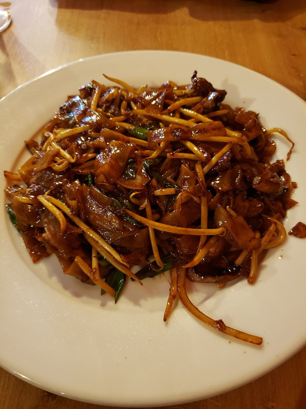Deeply caramelised beef ho fun, noodles darkened and blistered from high-heat wok frying